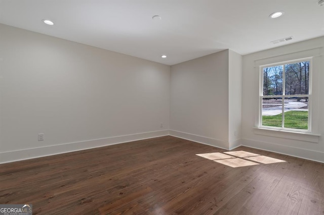 unfurnished room featuring dark wood-style floors, recessed lighting, and baseboards