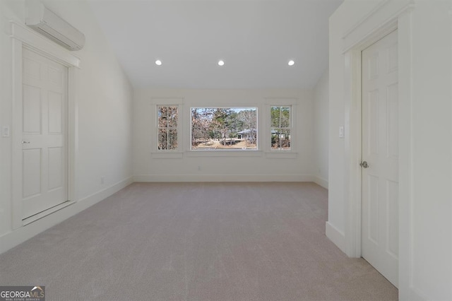 unfurnished room featuring baseboards, light colored carpet, vaulted ceiling, a wall mounted AC, and recessed lighting