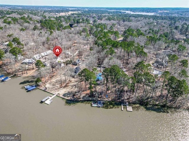 aerial view with a forest view and a water view