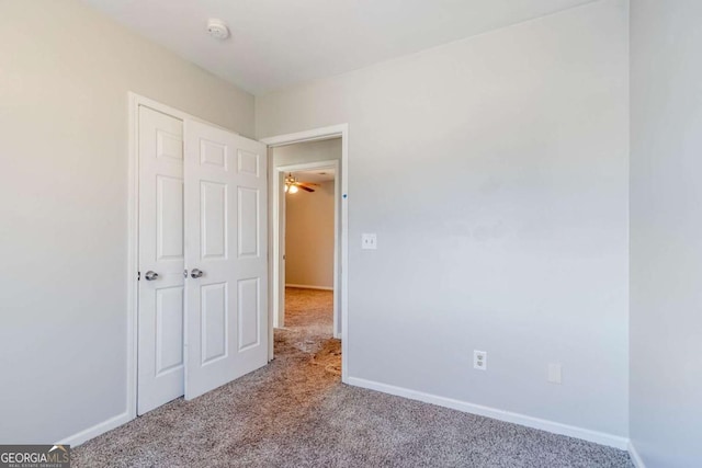 unfurnished bedroom featuring carpet flooring and baseboards