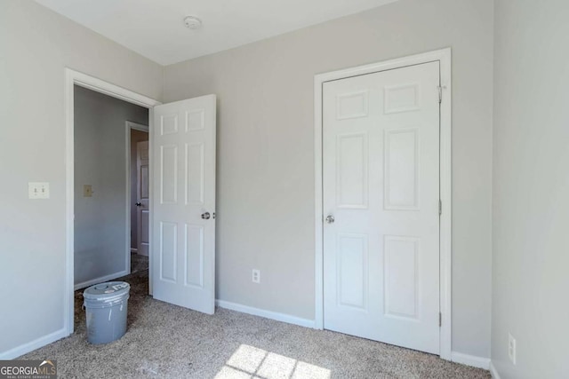 unfurnished bedroom with carpet floors and baseboards