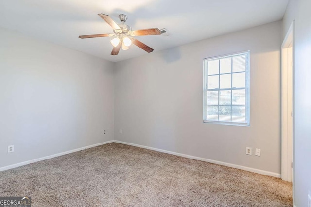 empty room with ceiling fan, carpet floors, and baseboards