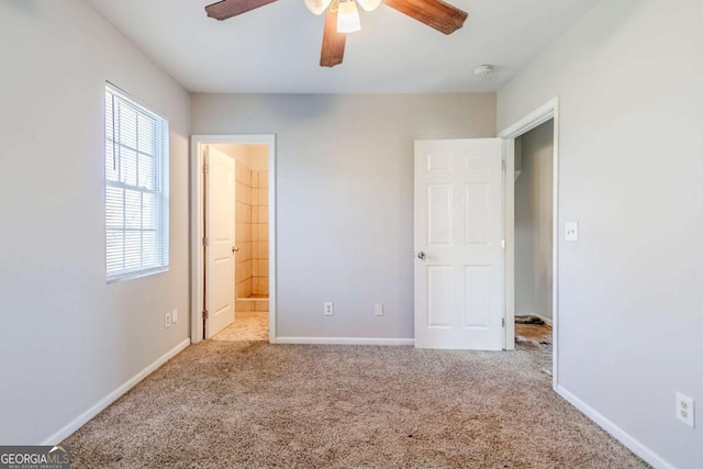 unfurnished bedroom with ensuite bathroom, ceiling fan, carpet flooring, and baseboards