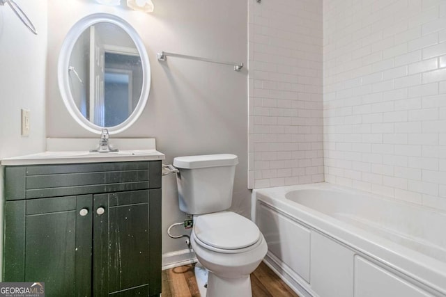 full bath with toilet, shower / bathtub combination, wood finished floors, and vanity