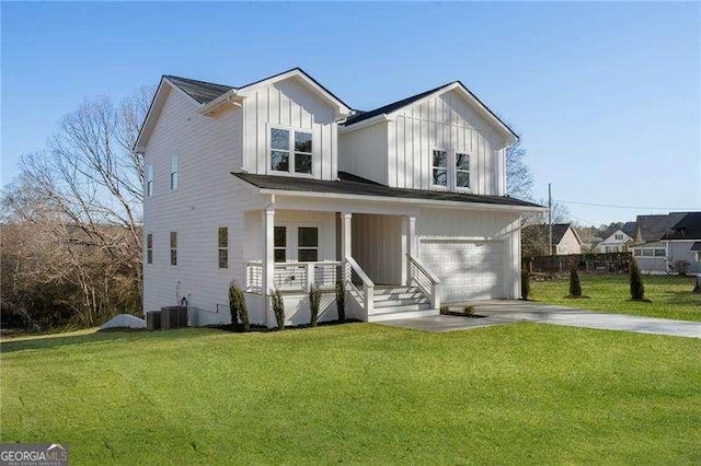 modern farmhouse with a porch, a front yard, driveway, and board and batten siding