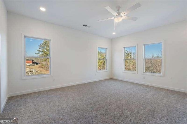 empty room with recessed lighting, carpet flooring, visible vents, and baseboards