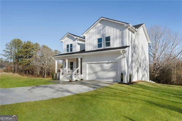 modern inspired farmhouse featuring a front lawn, concrete driveway, board and batten siding, and an attached garage