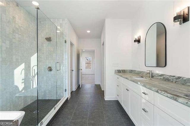 bathroom with tile patterned flooring, baseboards, a shower stall, and vanity