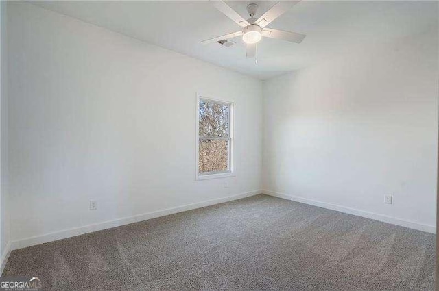 unfurnished room featuring a ceiling fan, carpet, visible vents, and baseboards