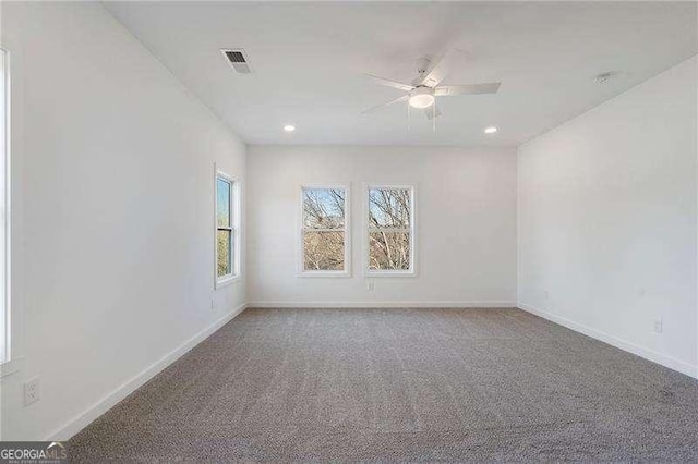 carpeted spare room with a ceiling fan, recessed lighting, and baseboards