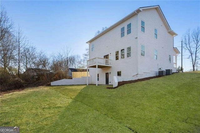 rear view of property with cooling unit and a lawn