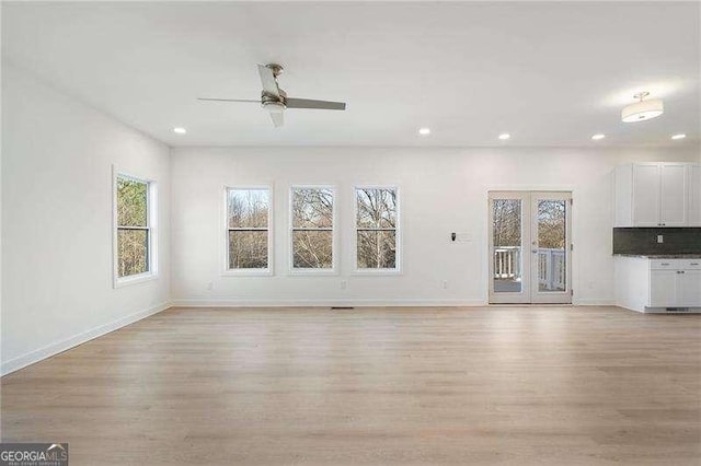 unfurnished living room with light wood-style floors, baseboards, and recessed lighting