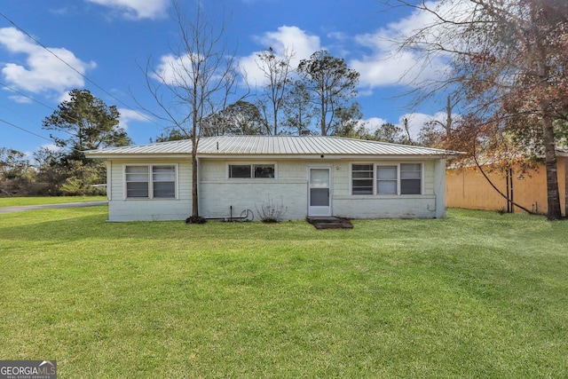 view of front facade featuring a front yard, metal roof, and fence