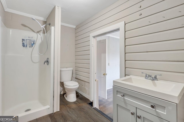 full bath featuring toilet, a stall shower, wood finished floors, and vanity