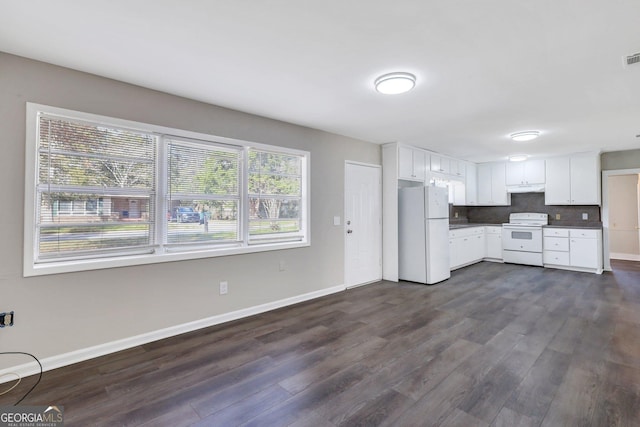 kitchen with dark wood-style flooring, backsplash, white cabinetry, white appliances, and baseboards