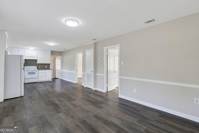 unfurnished living room featuring visible vents, dark wood finished floors, and baseboards