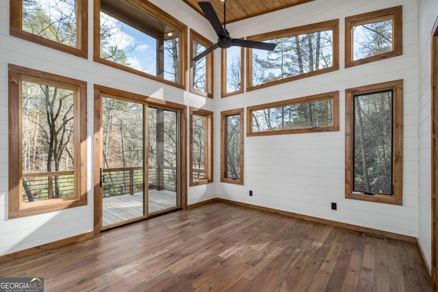 unfurnished sunroom featuring ceiling fan, lofted ceiling, and visible vents