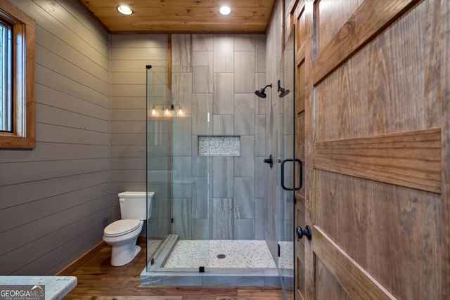 full bathroom featuring a stall shower, toilet, wooden ceiling, wood finished floors, and recessed lighting