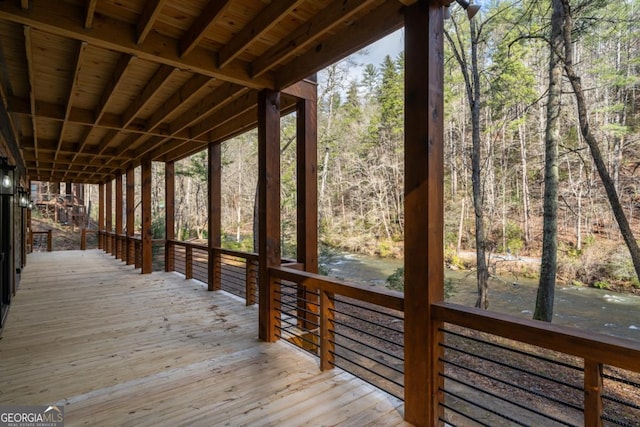 wooden deck featuring a view of trees