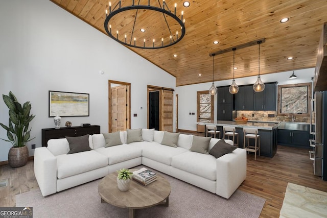 living area with high vaulted ceiling, wood finished floors, wood ceiling, and recessed lighting