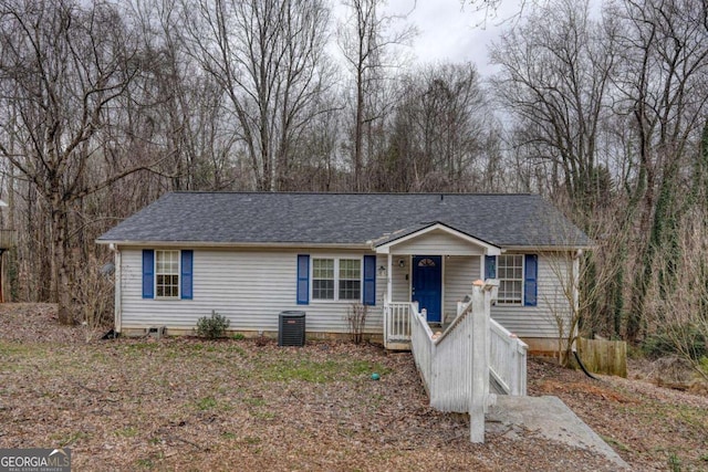 single story home featuring central AC unit and a shingled roof