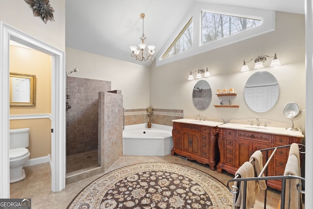 bathroom with a garden tub, toilet, vanity, a tile shower, and tile patterned floors