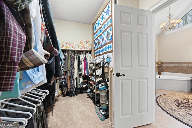 walk in closet featuring a chandelier and tile patterned flooring