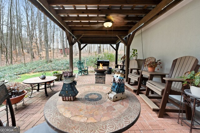 view of patio / terrace with an outdoor fire pit and outdoor dining area