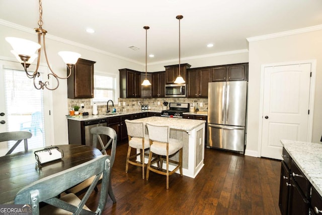 kitchen featuring decorative backsplash, dark wood-type flooring, stainless steel appliances, dark brown cabinets, and a sink