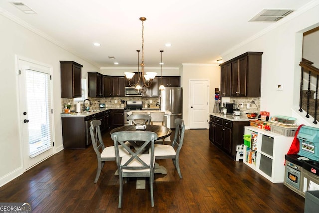 dining space featuring visible vents, dark wood-type flooring, stairs, crown molding, and a chandelier