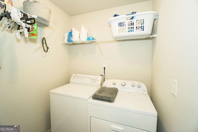 washroom featuring laundry area and washing machine and clothes dryer