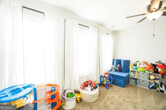 recreation room featuring ceiling fan and carpet floors