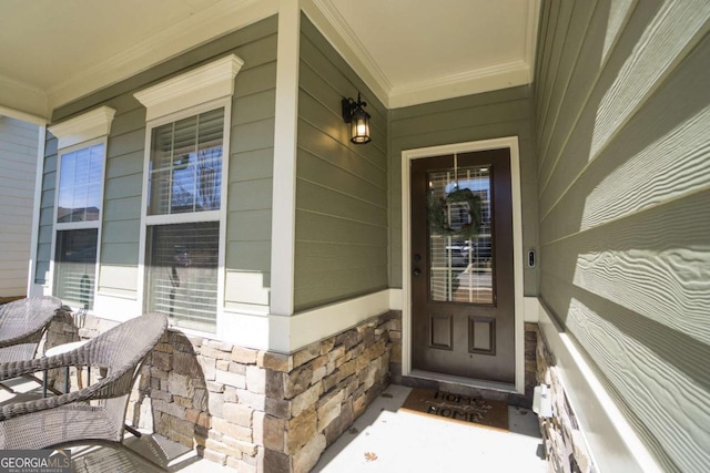 property entrance with stone siding and covered porch