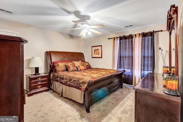 bedroom featuring light colored carpet, visible vents, and ceiling fan