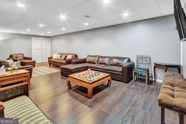 living room featuring dark wood-type flooring, visible vents, and recessed lighting