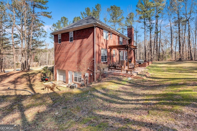 view of side of home with a garage, brick siding, a yard, a pergola, and a chimney