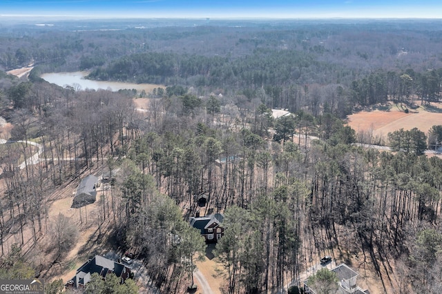 aerial view featuring a water view and a wooded view