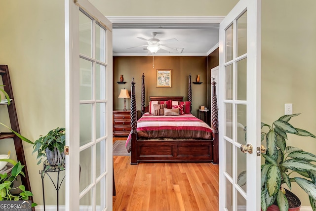 bedroom with ornamental molding, french doors, and wood finished floors