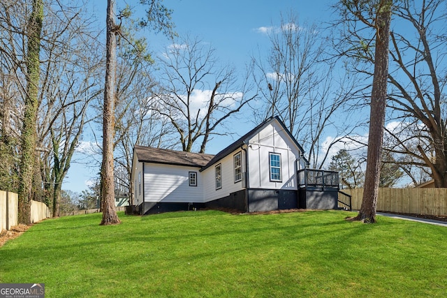 view of property exterior featuring crawl space, fence, and a lawn