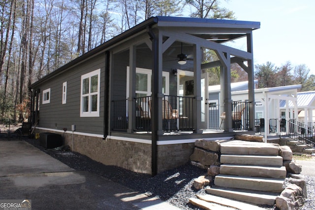 view of front of house featuring central air condition unit and stairs