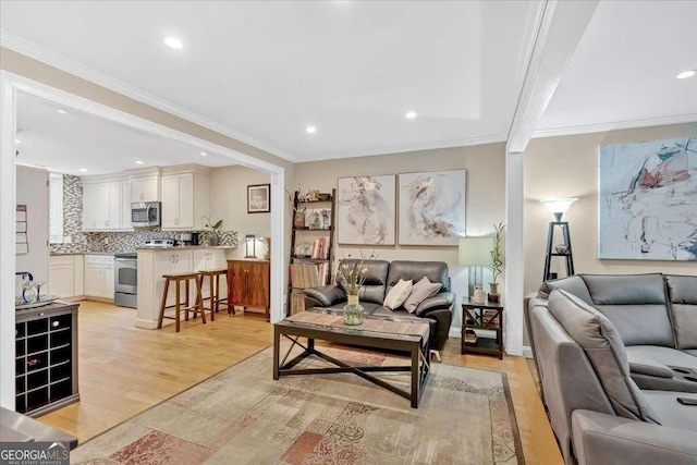 living room with recessed lighting, light wood-style flooring, and crown molding