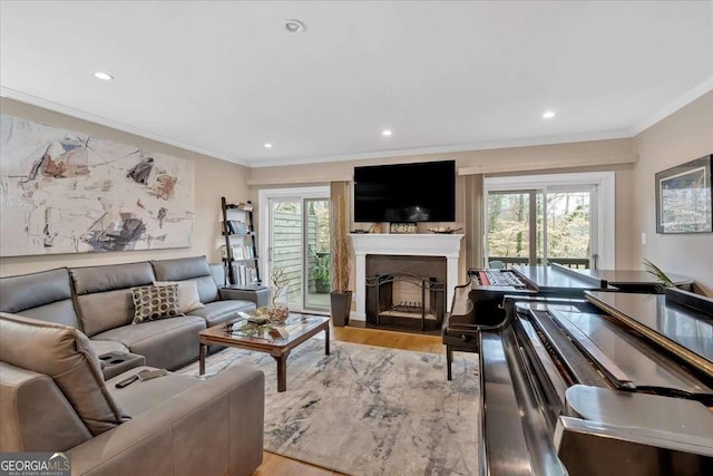 living area with ornamental molding, a wealth of natural light, and wood finished floors