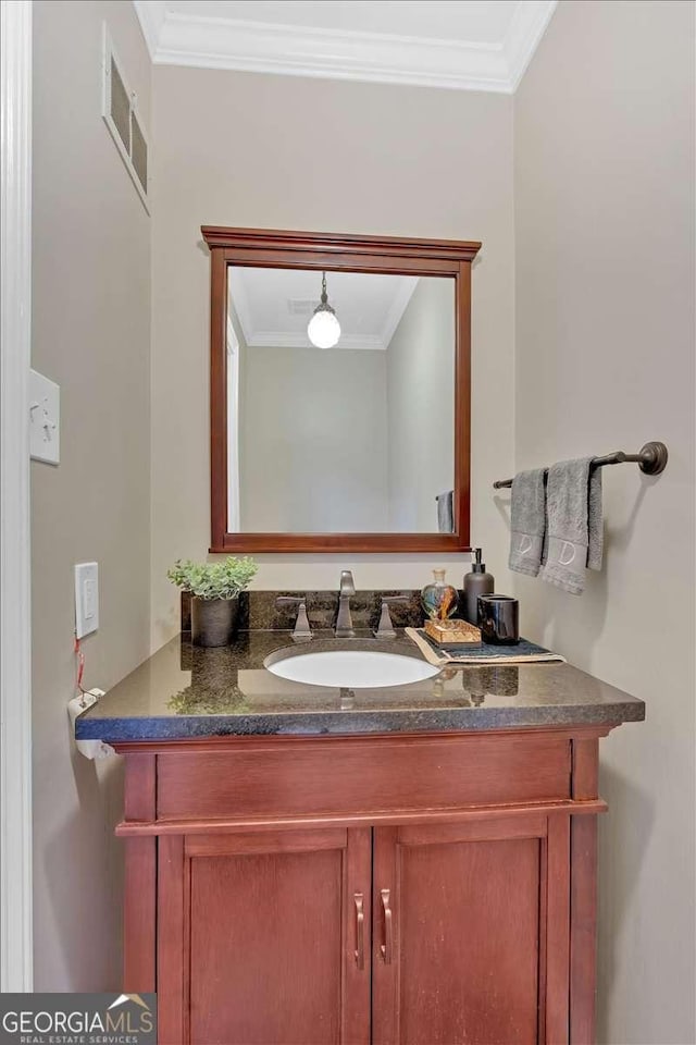 bathroom featuring vanity, visible vents, and ornamental molding