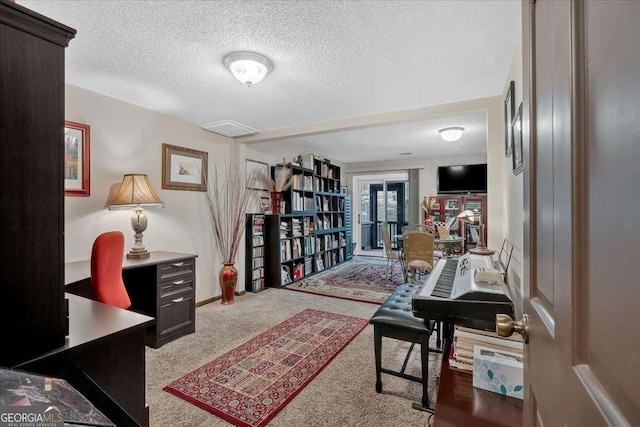 office space with carpet and a textured ceiling