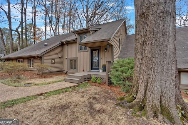 view of front of home with a shingled roof