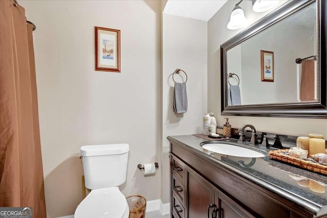 bathroom featuring toilet and vanity