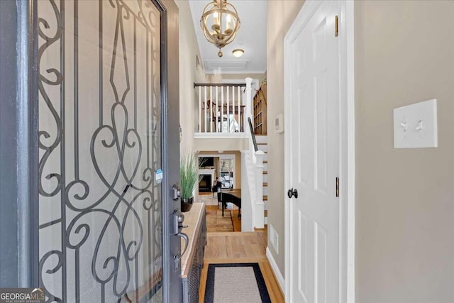 entryway with a fireplace and wood finished floors