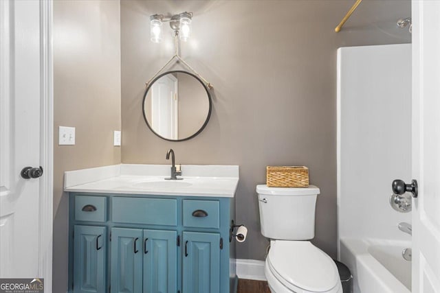 bathroom featuring baseboards, toilet, vanity, and shower / tub combination