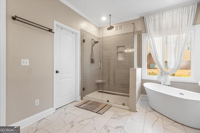 full bathroom with marble finish floor, crown molding, a freestanding bath, a shower stall, and baseboards