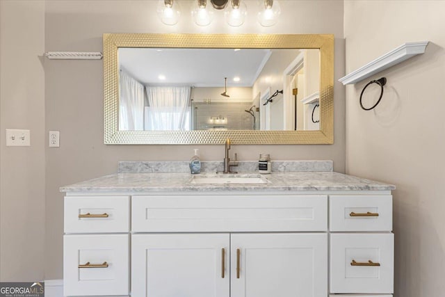 bathroom with tiled shower and vanity